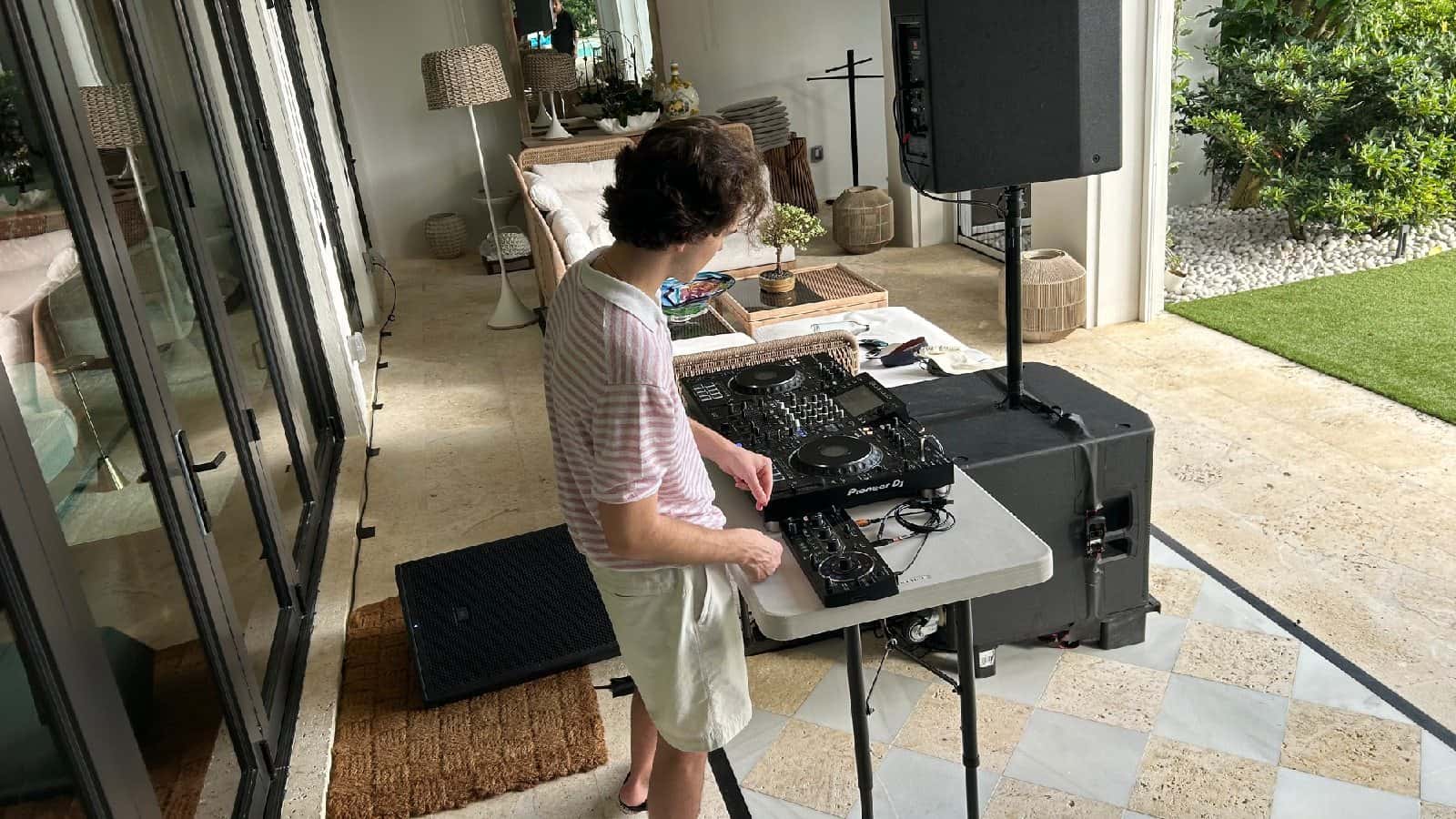 DJ operating a compact effects-linked performance setup