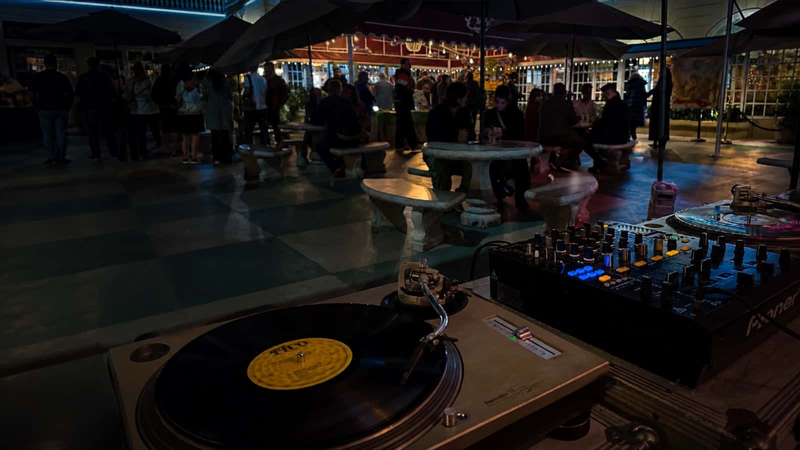 Vinyl turntable and DJ mixer in use at an outdoor event