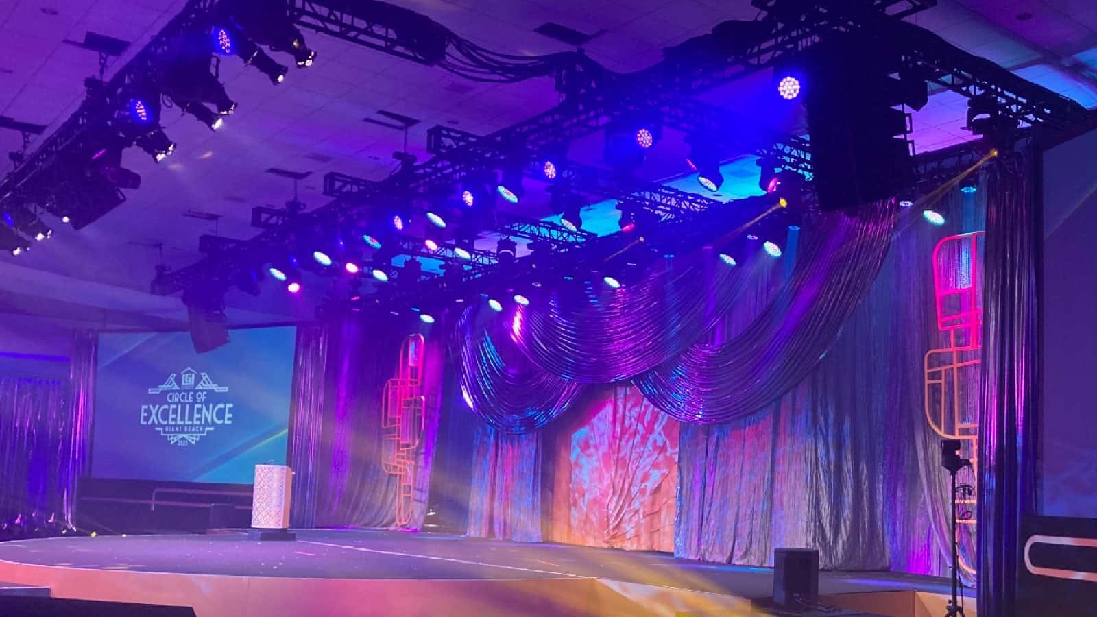 Colorful stage-lighting rig with multiple PAR fixtures illuminating a stage