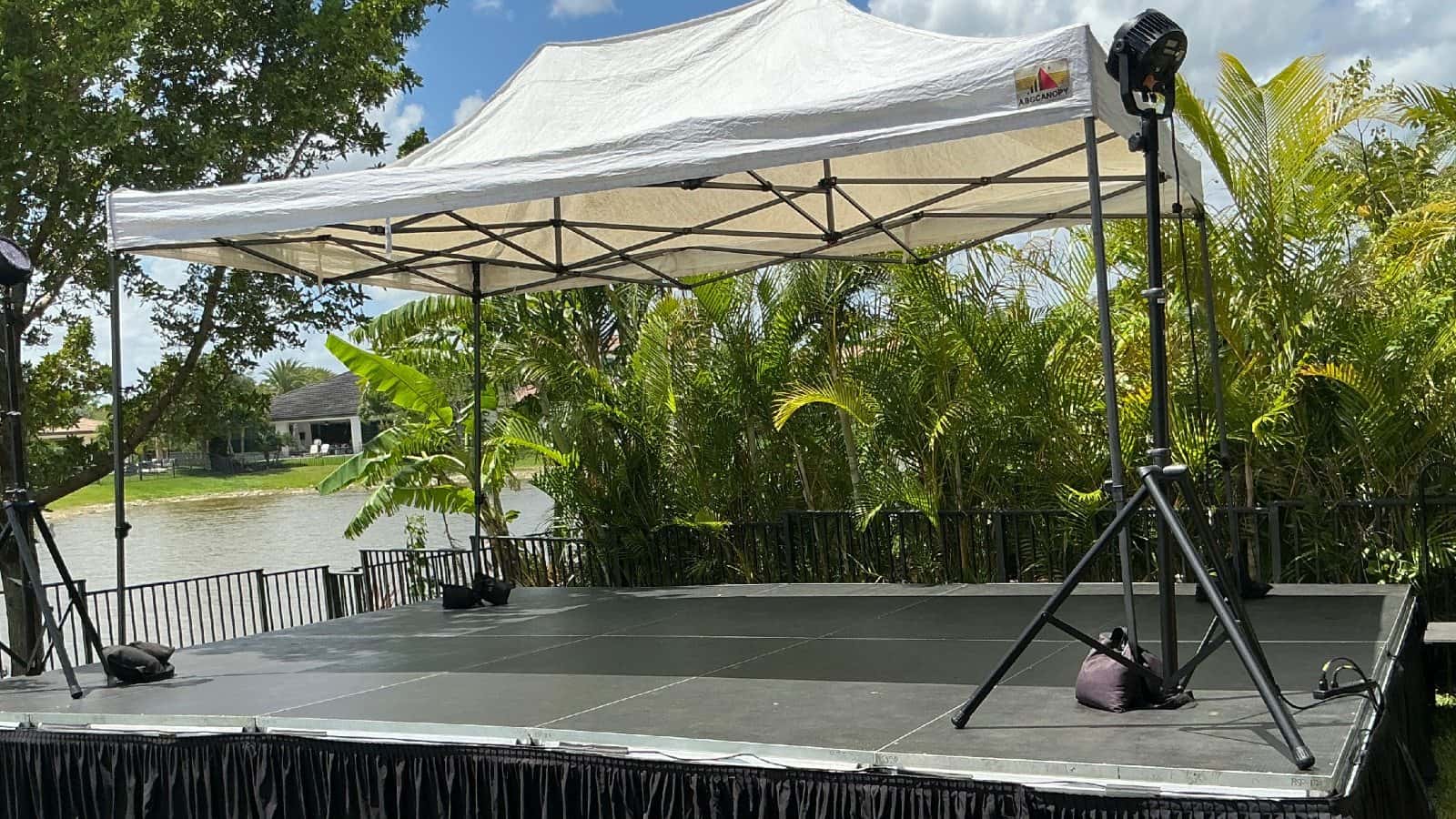 White canopy installed over an outdoor stage and production area
