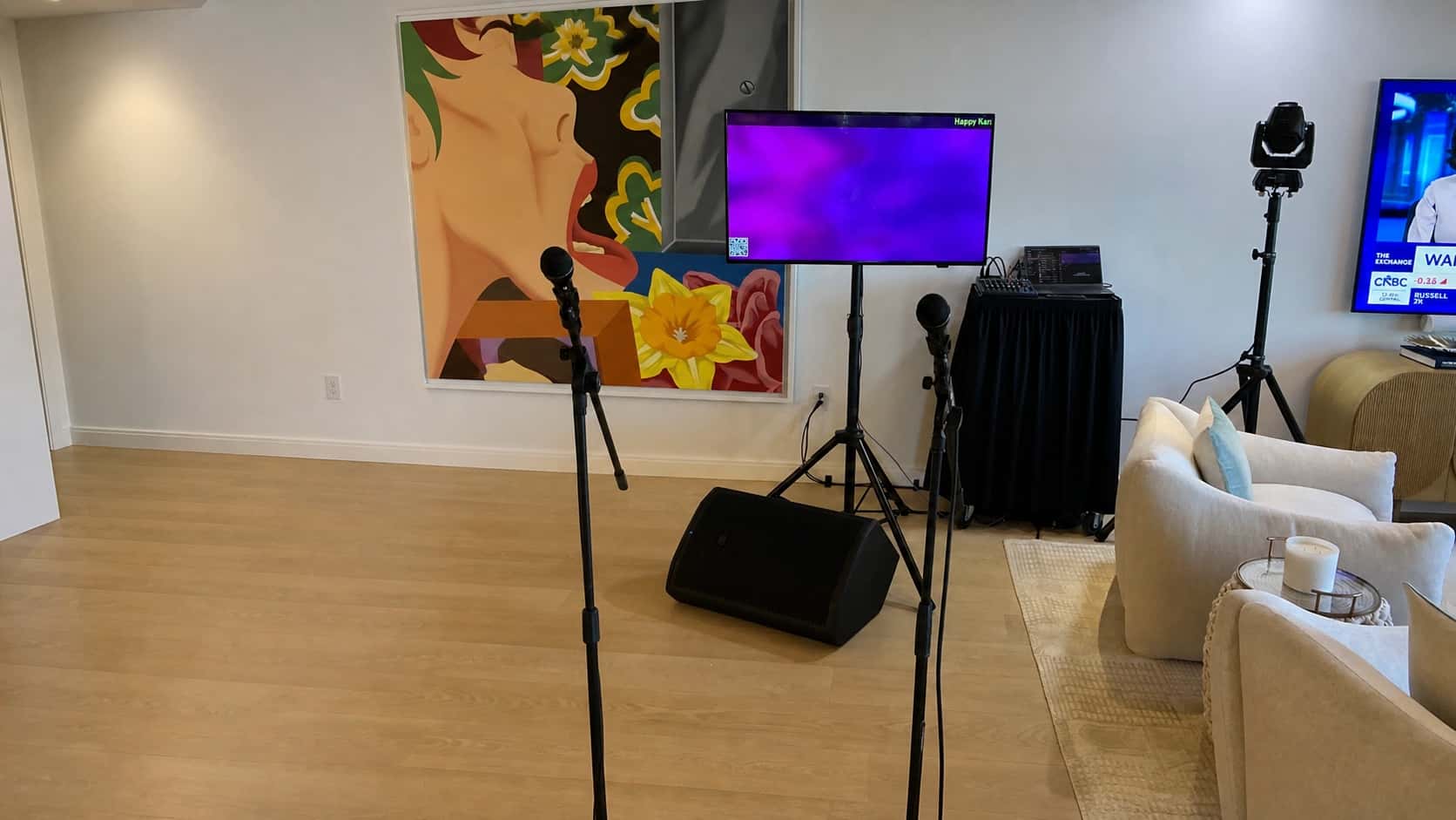 Karaoke rental setup with microphones, screen, speaker, and mixer in an Orlando event space