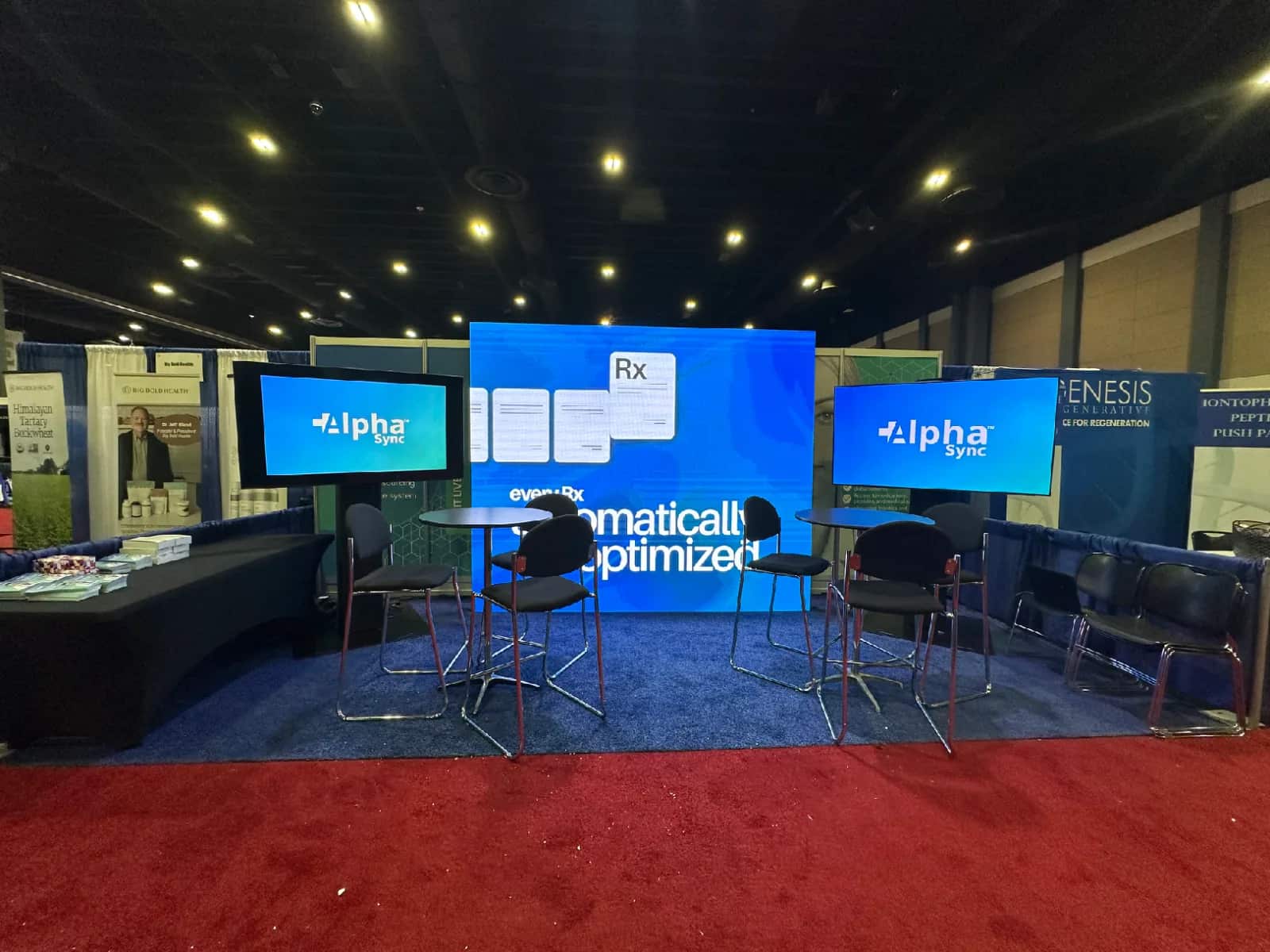 Alpha Sync trade show booth with a center LED wall and two presentation displays