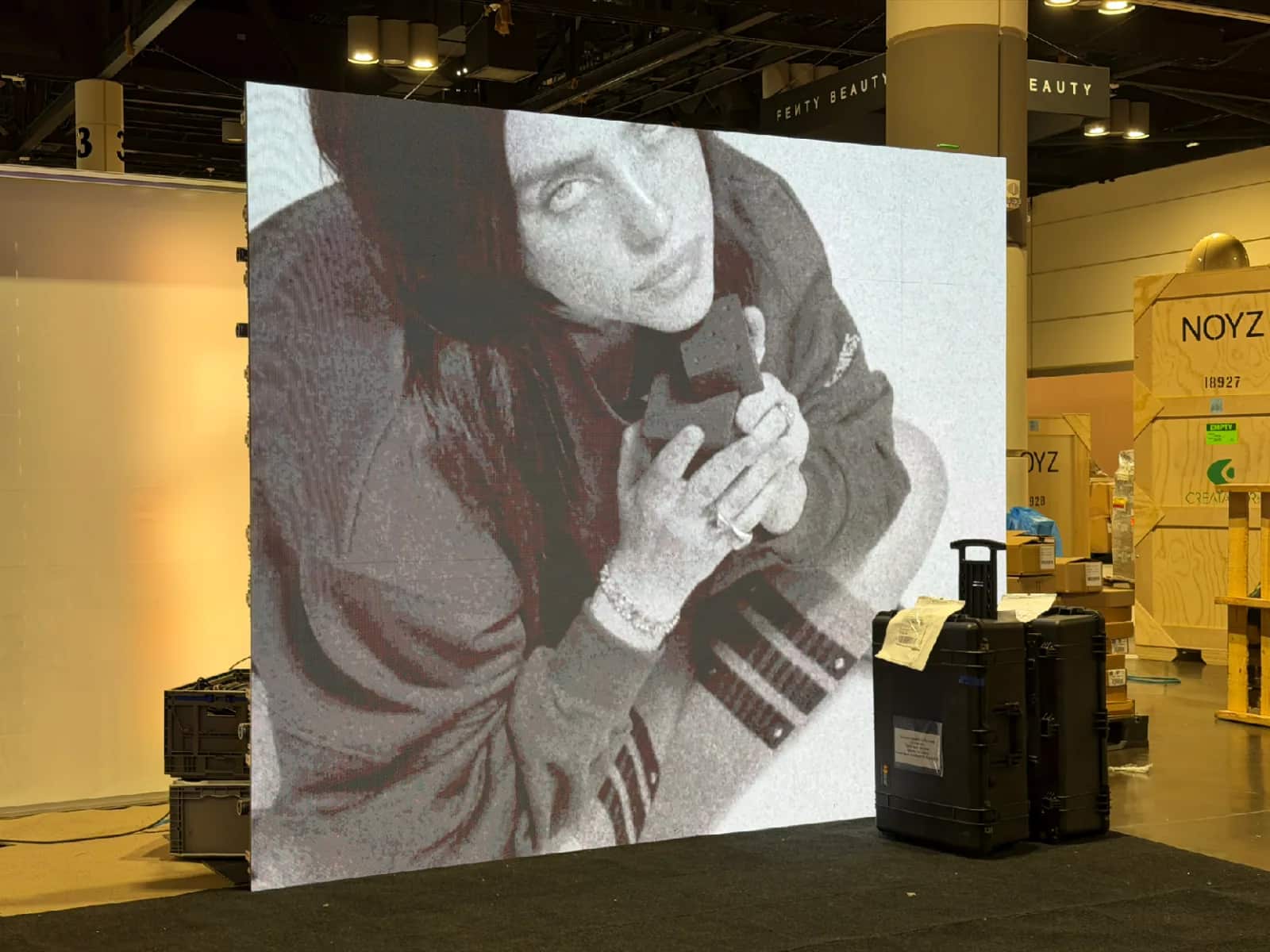Fenty Beauty trade show LED wall during installation with production cases nearby