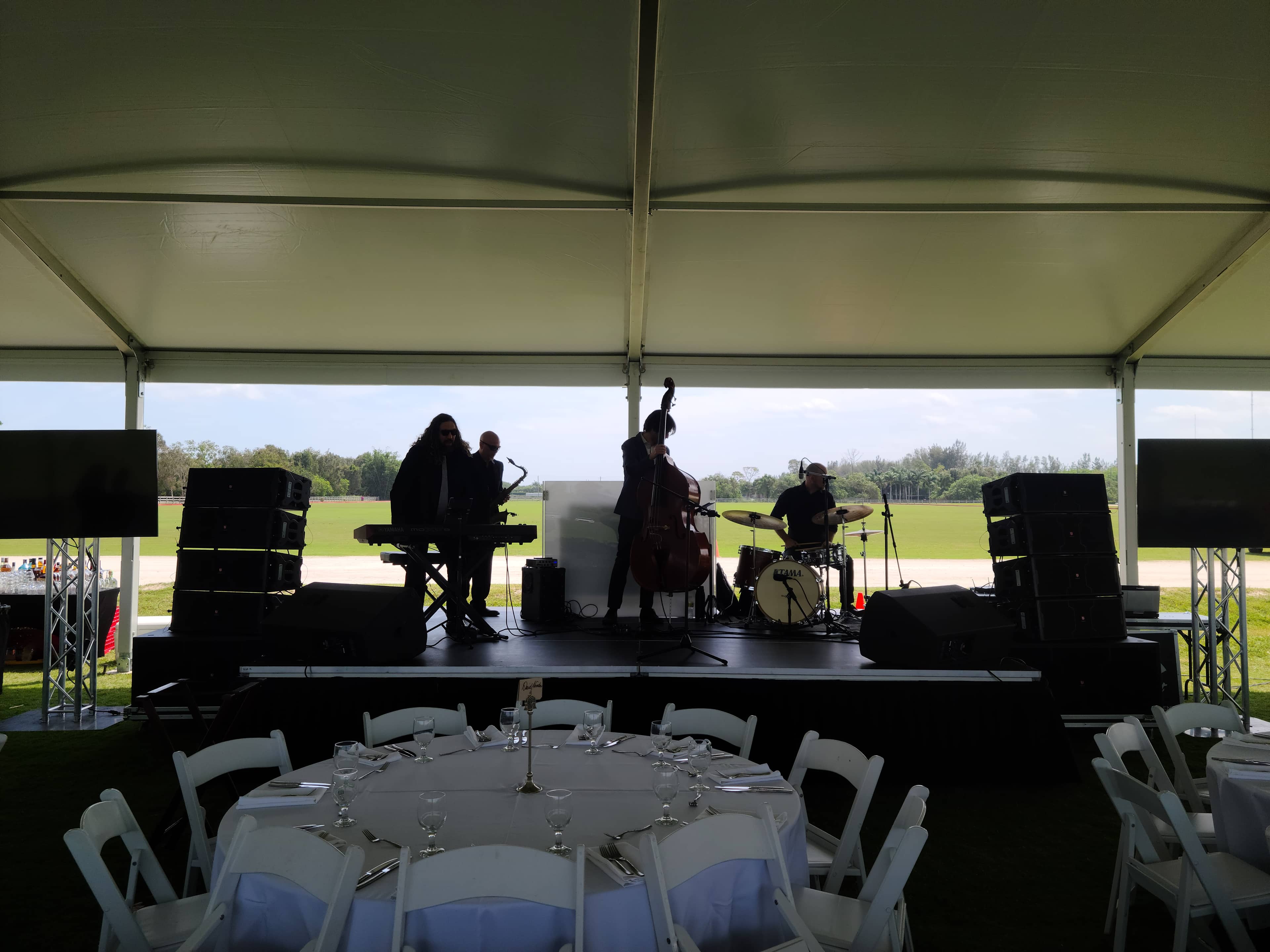 Professional event speakers supporting a live band outdoors