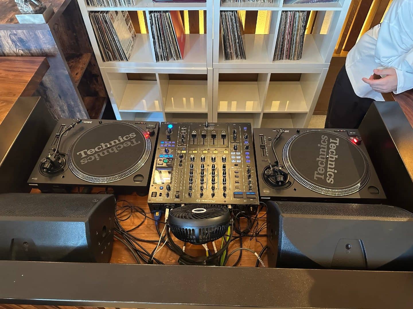 Two Technics turntables arranged around a Pioneer DJ mixer