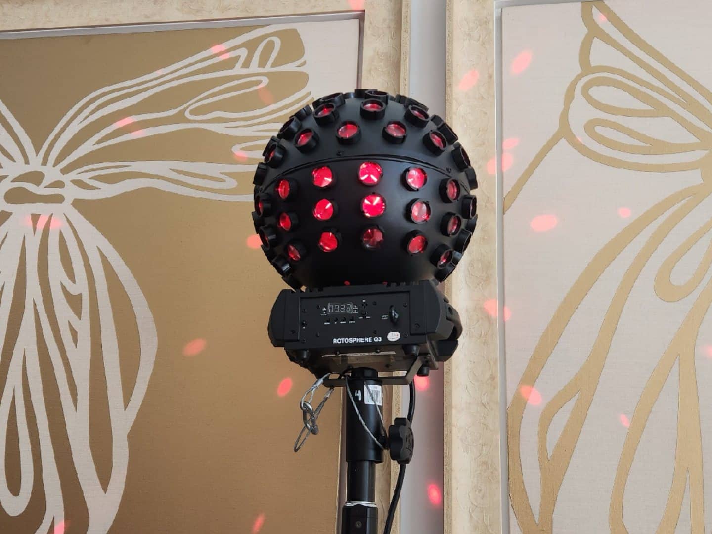 Chauvet Rotosphere mirror-ball effect light projecting red dots onto a wall