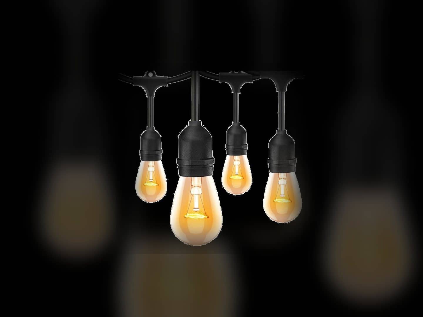 Four warm bistro bulbs hanging from a black string-light cable