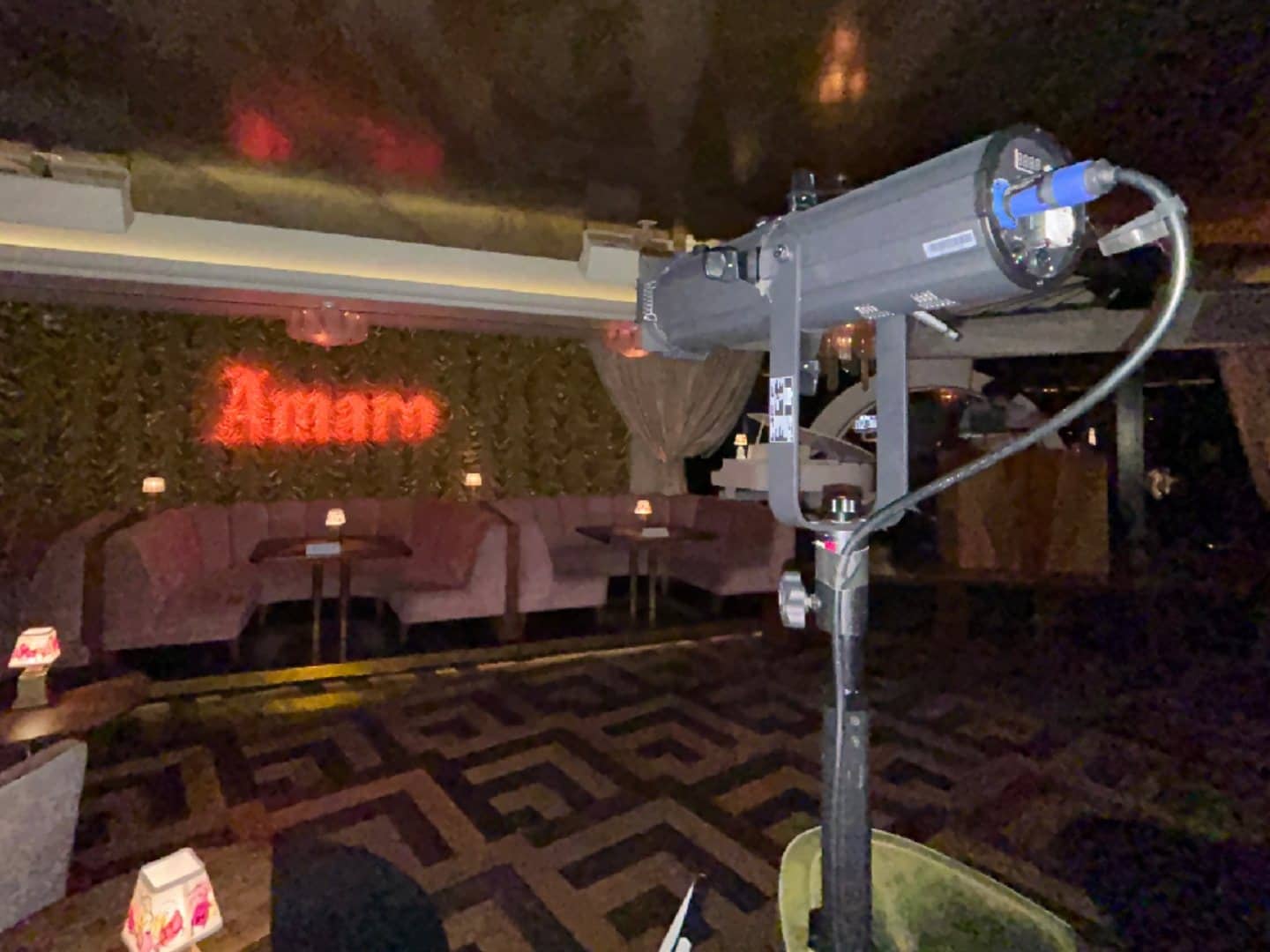Gobo projector in the foreground aimed at a custom name projection on an interior wall