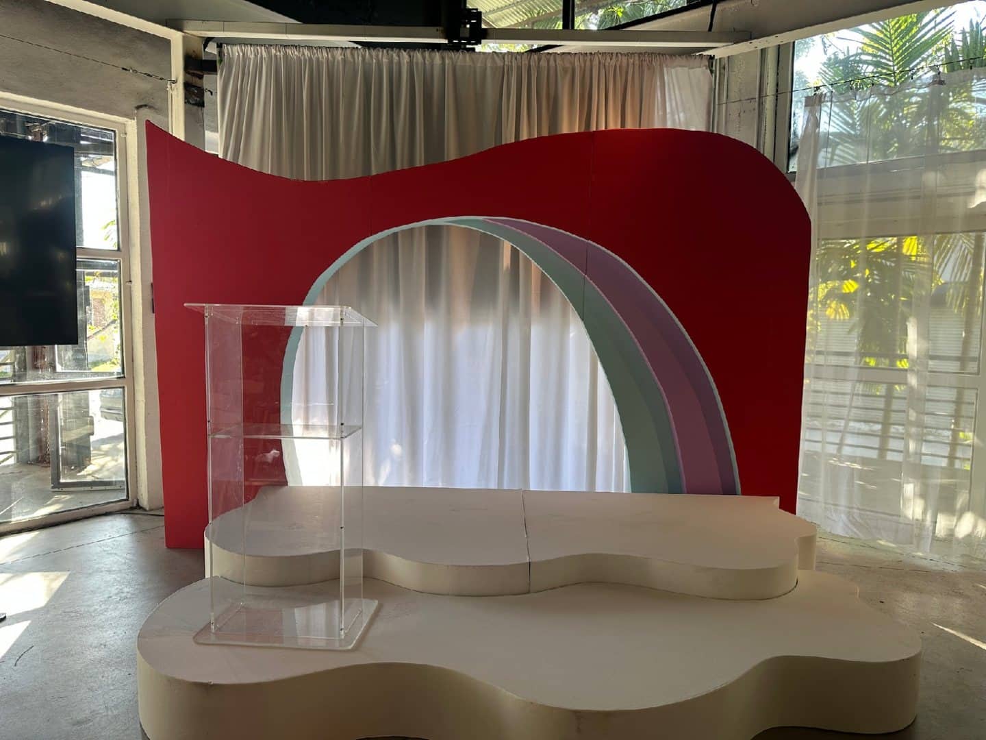 Clear acrylic podium positioned on a small presentation stage