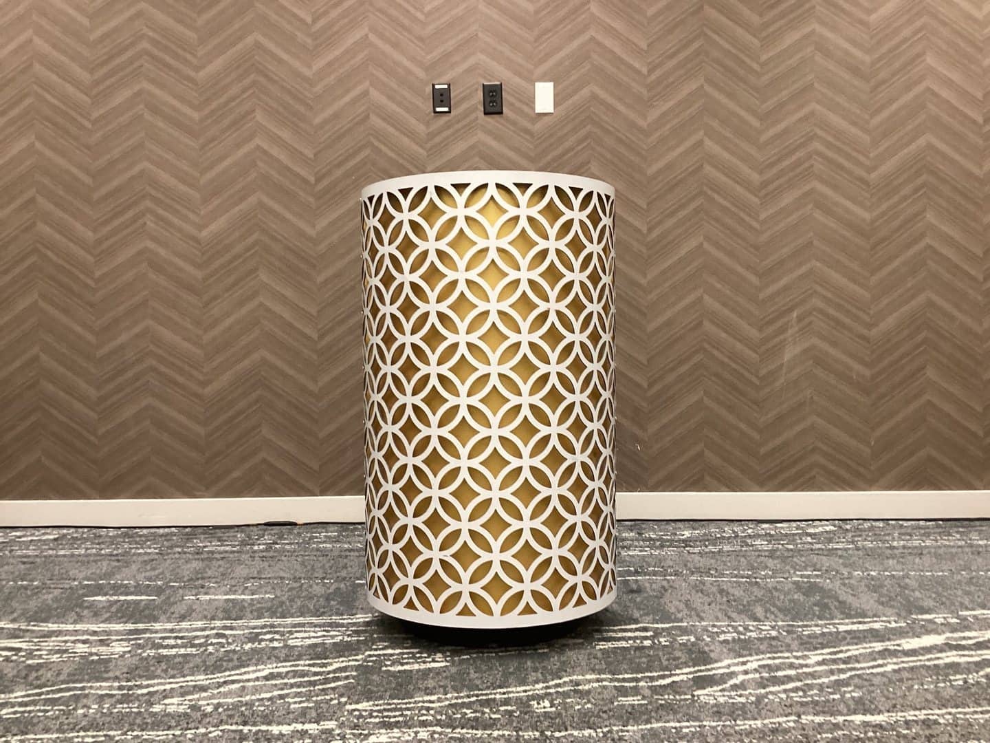 Gold-accent podium with a white presentation surface in an indoor venue