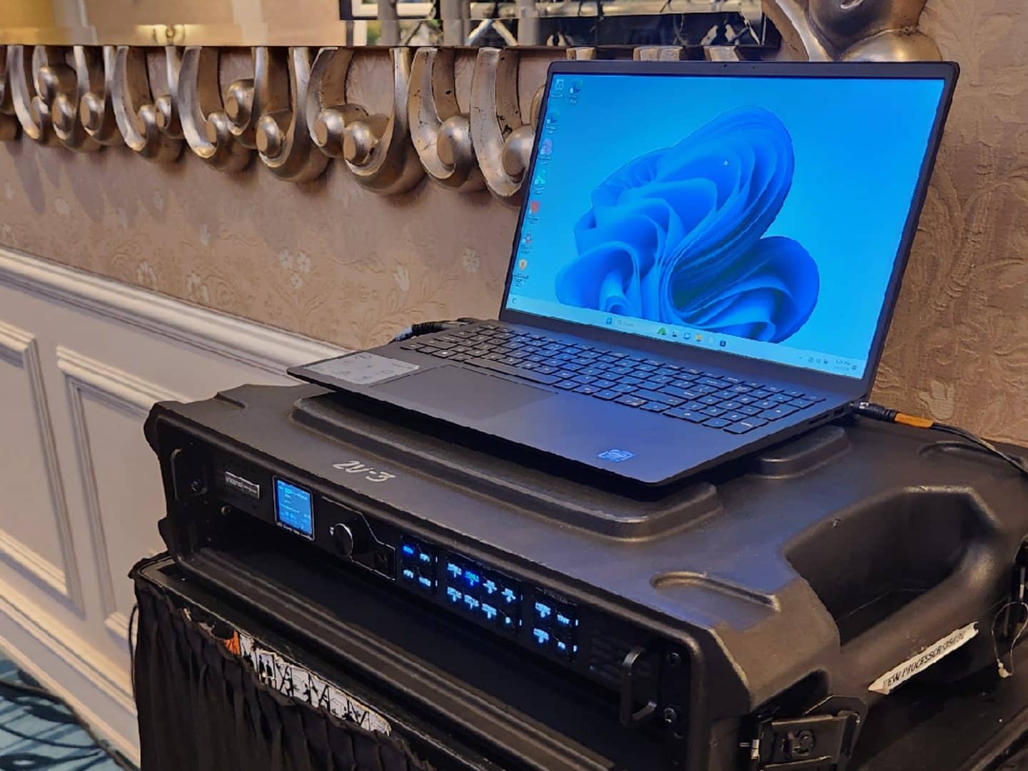 Separate Presentation Laptop resting on production equipment with a cable connected; Laptop Stand not pictured