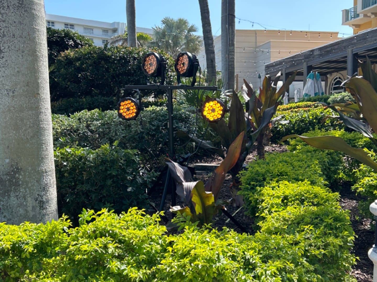 Black sand weight secured at the base of an outdoor lighting stand