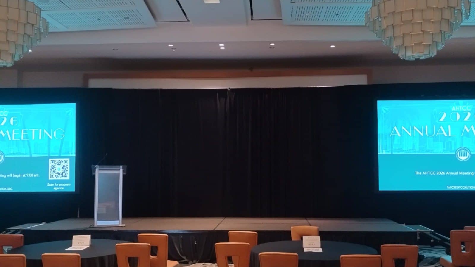 Black pipe and drape installed across a South Florida conference stage