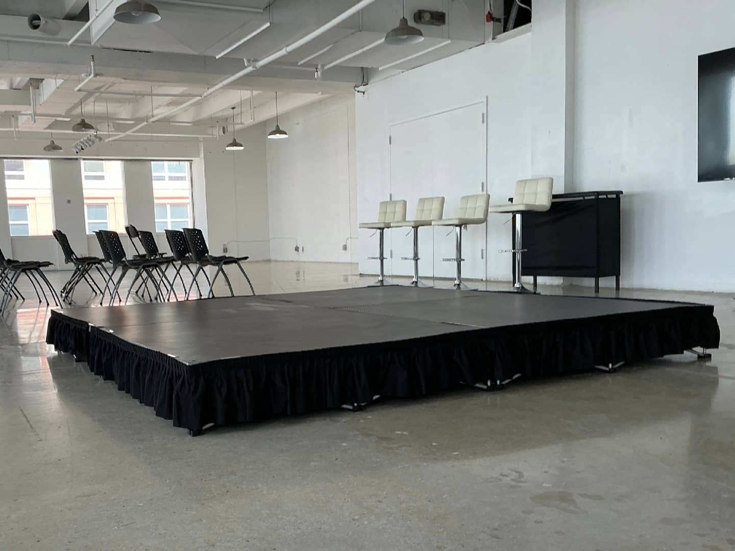Finished modular stage platform with a professional event backdrop