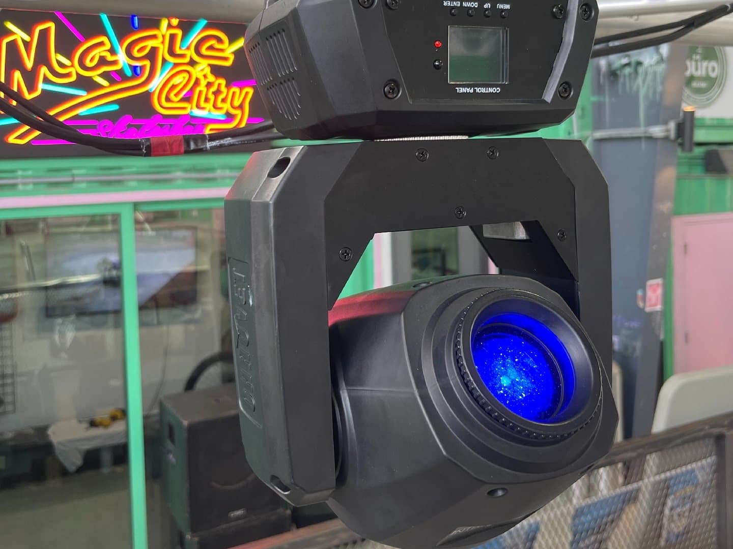 Close view of a Chauvet moving-head spotlight with its blue lens visible