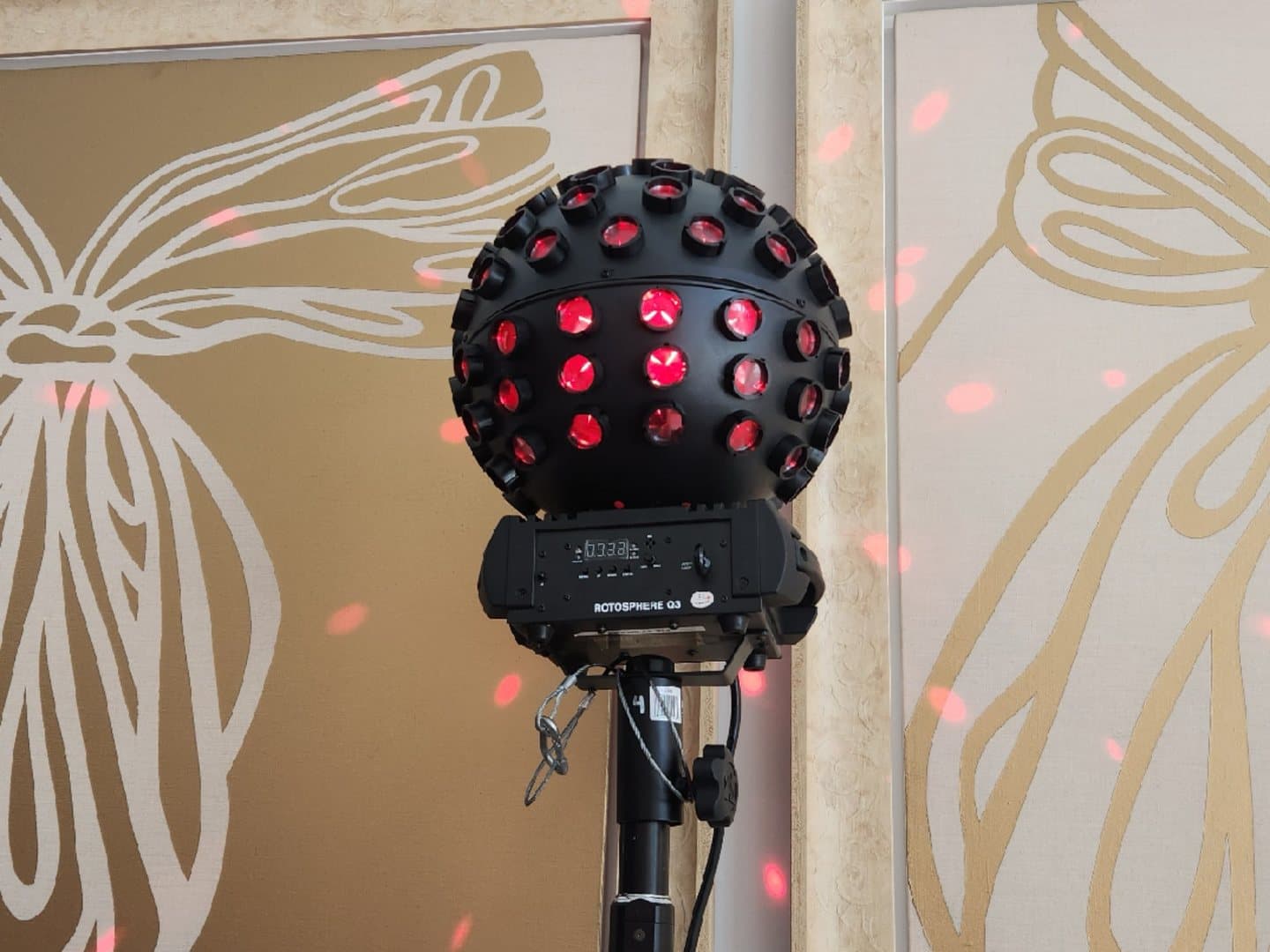 Chauvet Rotosphere mirror-ball effect light projecting red dots onto a wall
