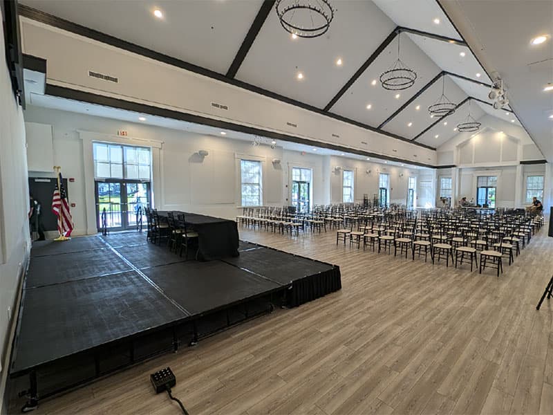 Portable stage illuminated by stage lights