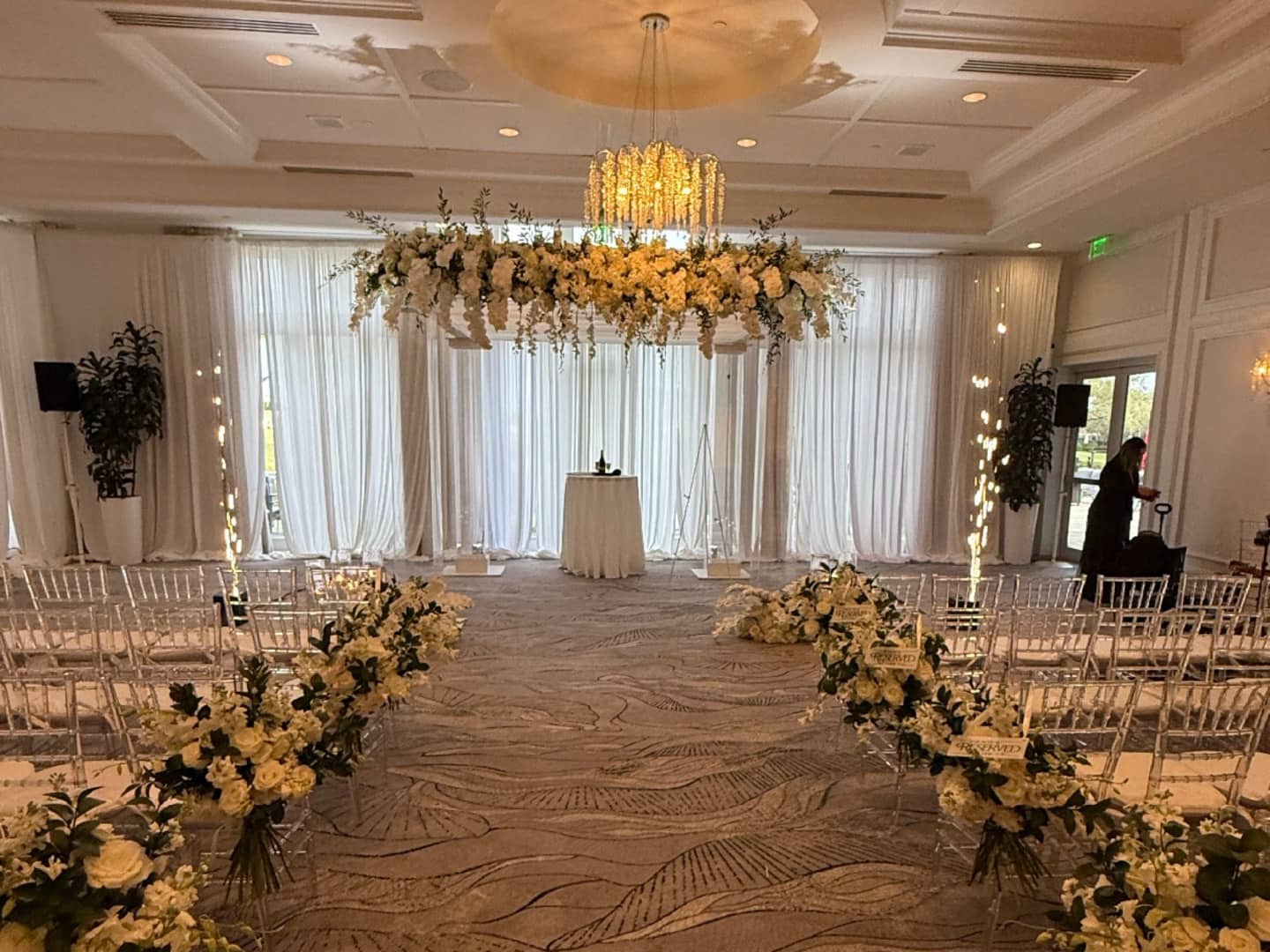 Two cold spark machines installed to frame an indoor ceremony aisle