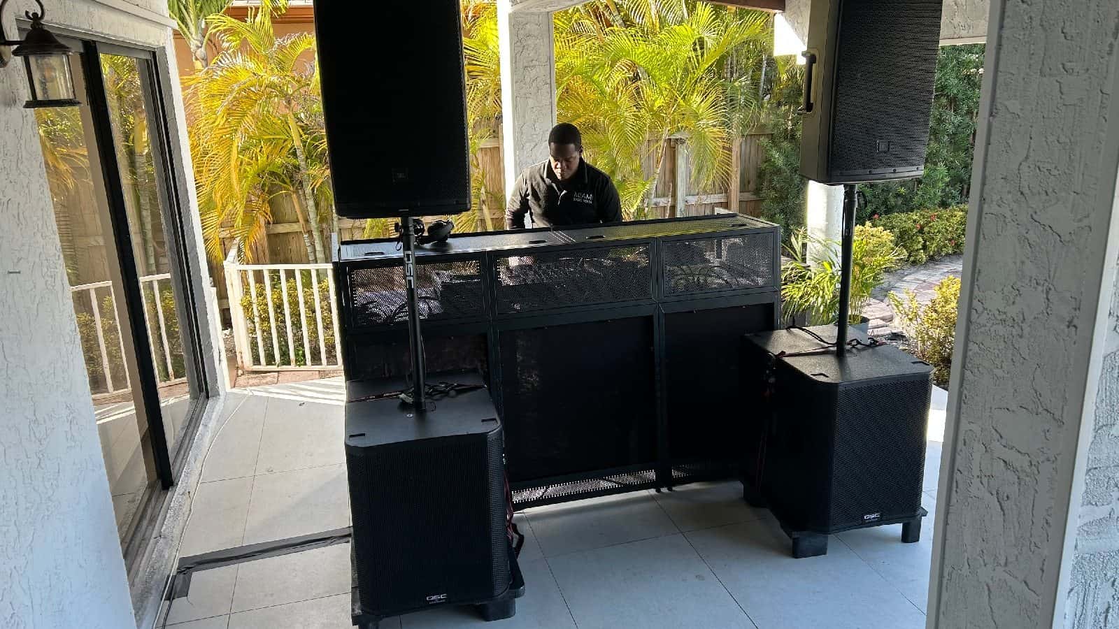 DJ performing behind a large portable event booth
