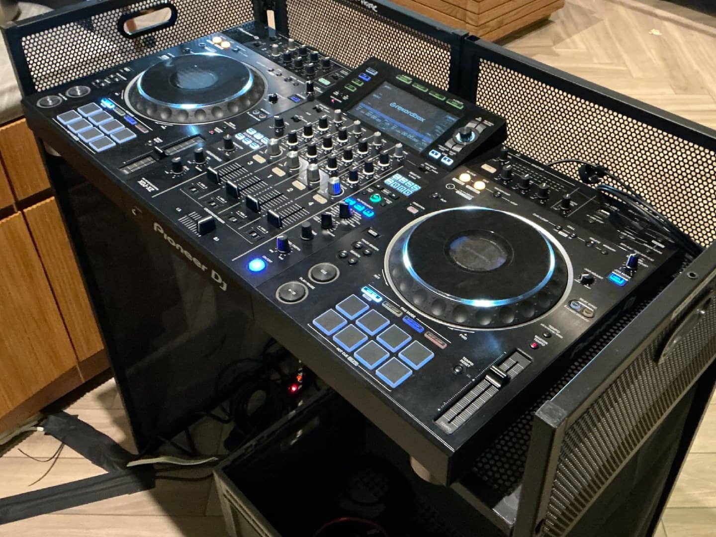 Pioneer DJ controller with decks, mixer section, pads, and screen visible