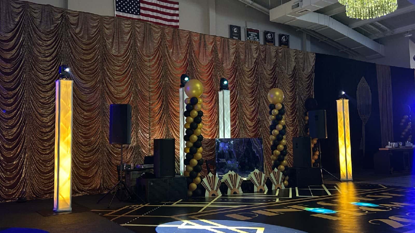 Lighting totems and mounted fixtures supporting a finished event design