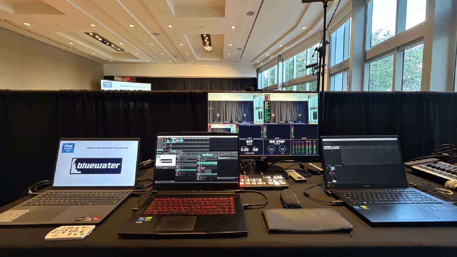 Multiple laptops arranged at a conference production control position