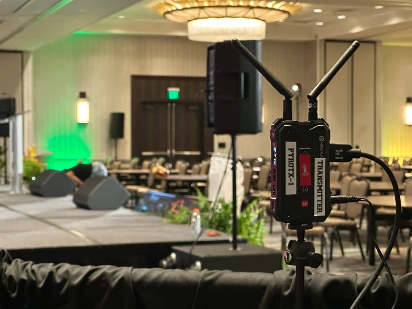 Wireless HDMI transmitter connected beside a conference stage