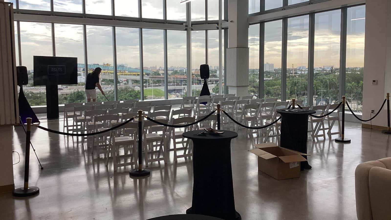 Black-rope stanchions guiding the entry to a Miami event seating area