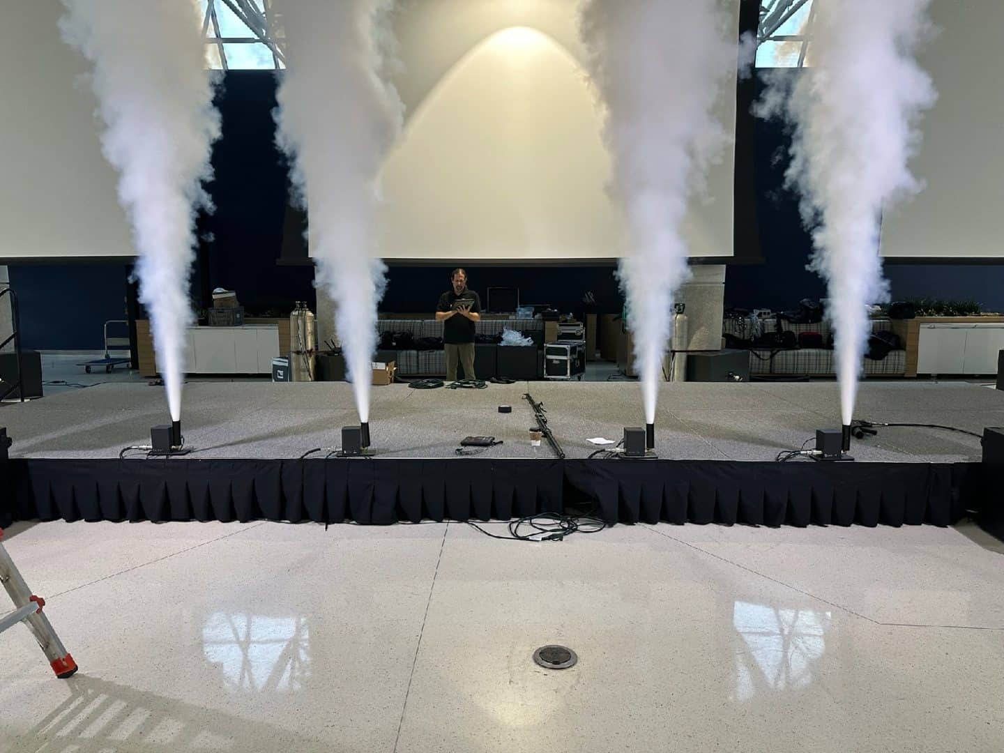 Four CO2 stage cannons producing vertical plumes during a controlled setup test