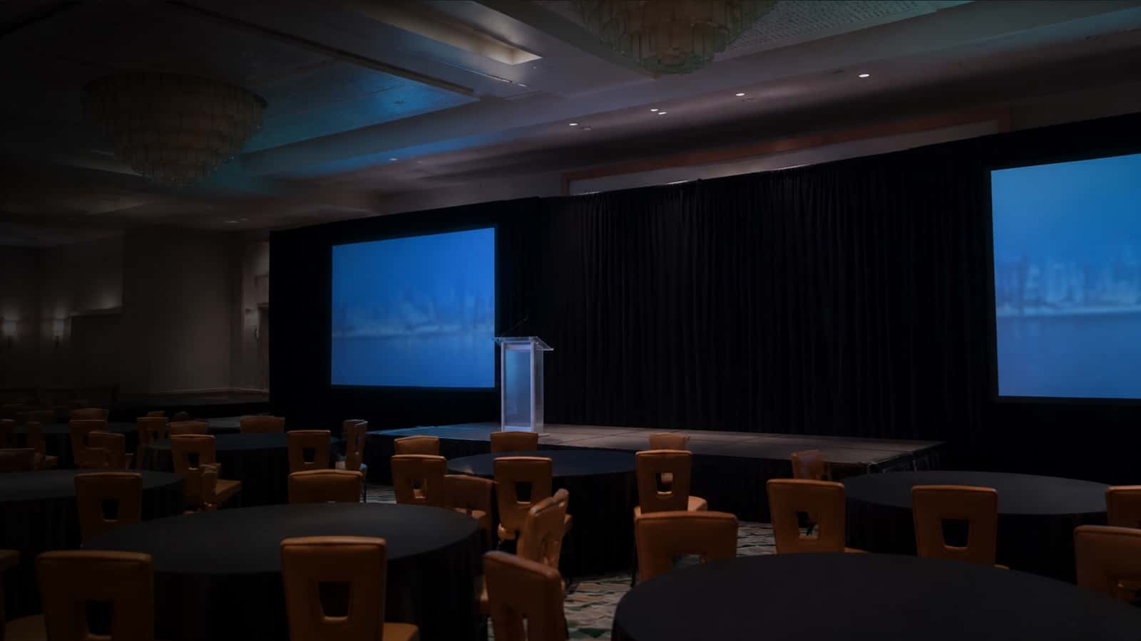 Black stage drape behind a ballroom presentation stage