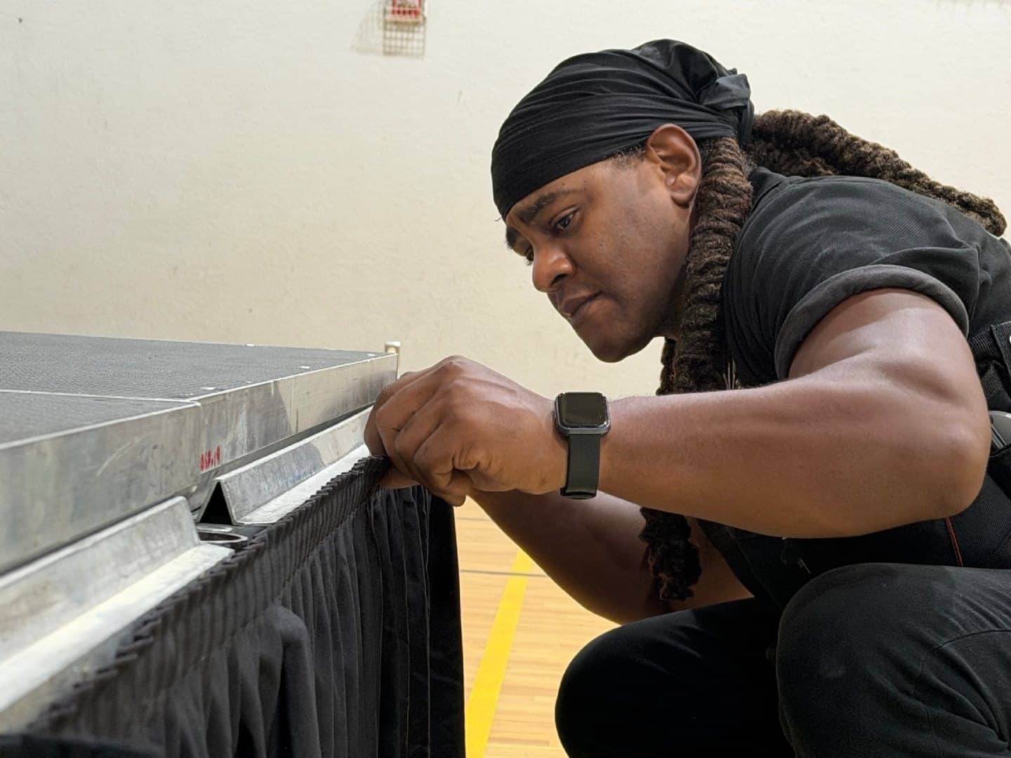 Technician finishing the skirted edge of a modular stage riser
