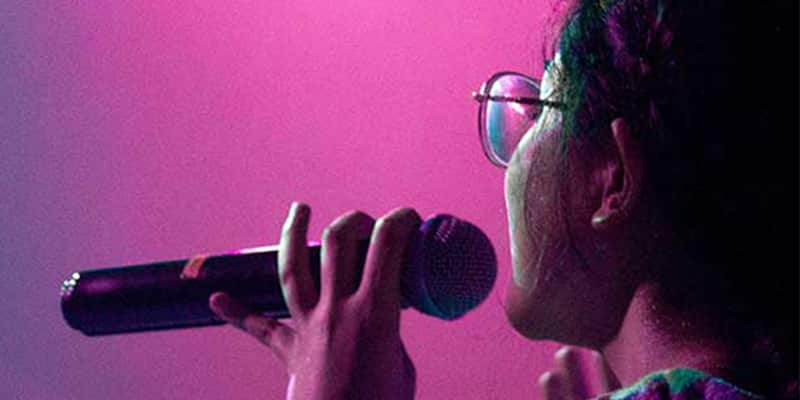 Singer using a microphone during a live karaoke performance