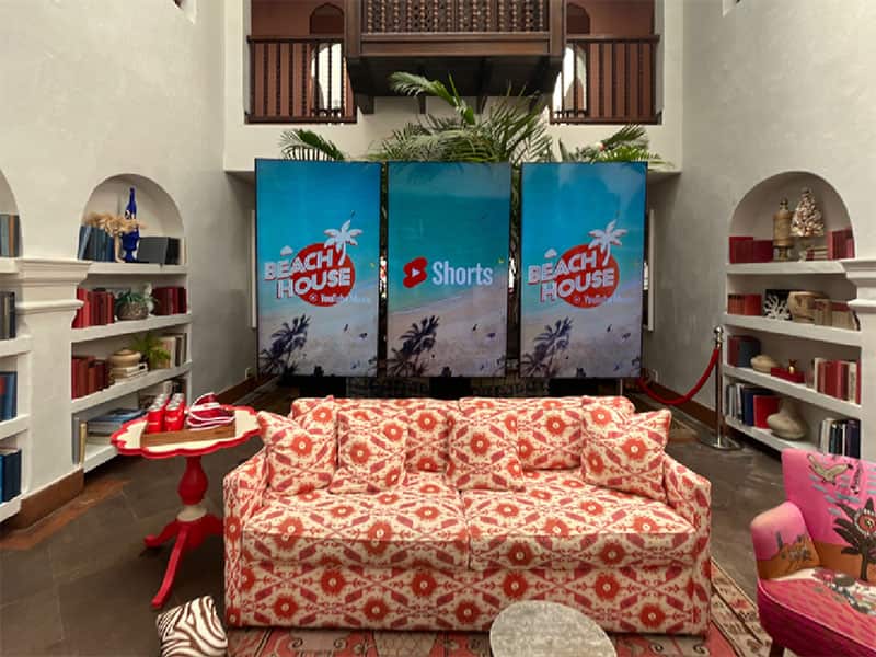 Three portrait flat-screen displays used for branded event content